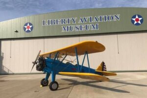 an airplane in front of a hangar at the Liberty Aviation Museum